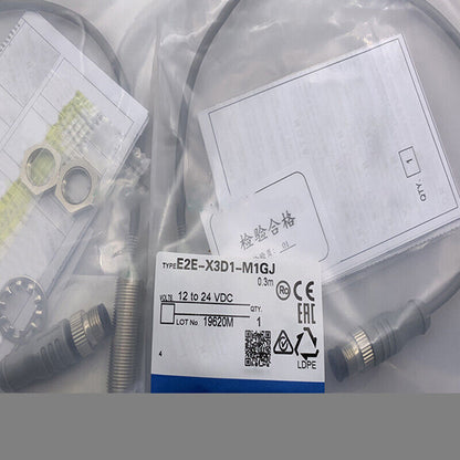 Omron E2E-X3D1-M1GJ proximity switch in packaging, 12-24VDC, with labels and CE/EAC marks, 0.3m cable.