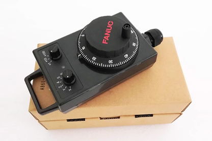 FANUC A860-0203-T015 Handwheel Pulse Generator, black control with dial, on a cardboard box, industrial automation part.