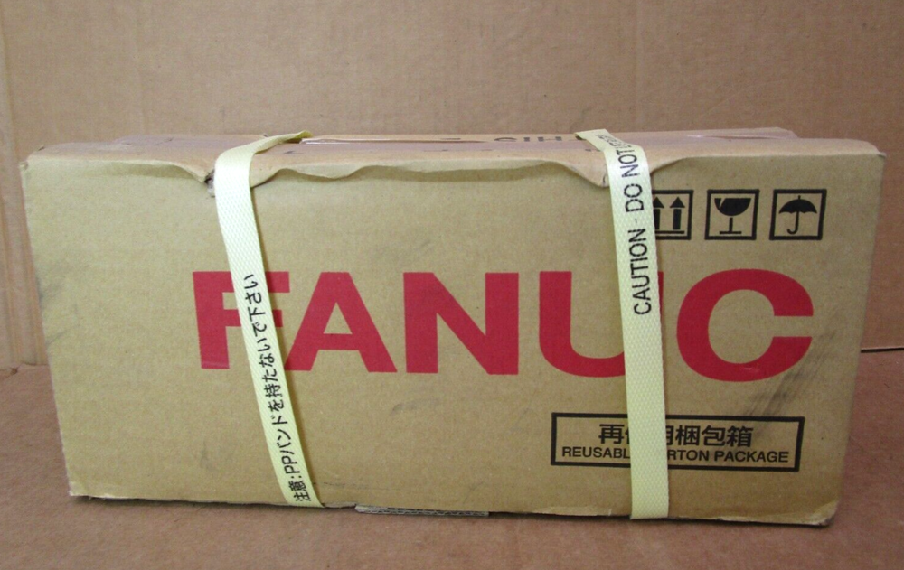 FANUC AC Servo Motor box, brown cardboard with red FANUC logo and caution labels.
