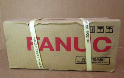 FANUC AC Servo Motor box, brown cardboard with red FANUC logo and caution labels.