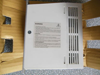 Mitsubishi MR-J2S-60A Servo Drive in packaging. Industrial automation part, white metal, warning label. MRJ2S60A.