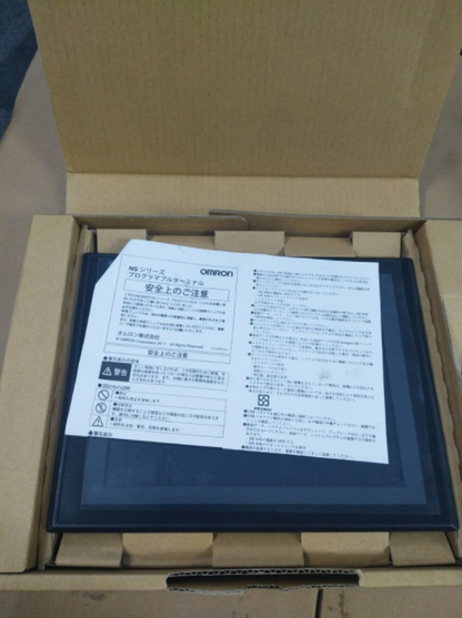 OMRON NS8-TV00B-ECV2 HMI touch screen panel inside the box, with safety instructions in Japanese.