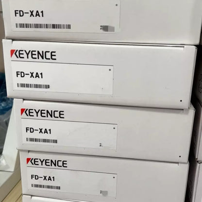Keyence FD-XA1 flow sensor boxes, product packaging for industrial automation equipment.