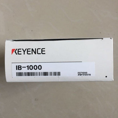 Keyence IB-1000 laser sensor box. White box with Keyence logo and product information.