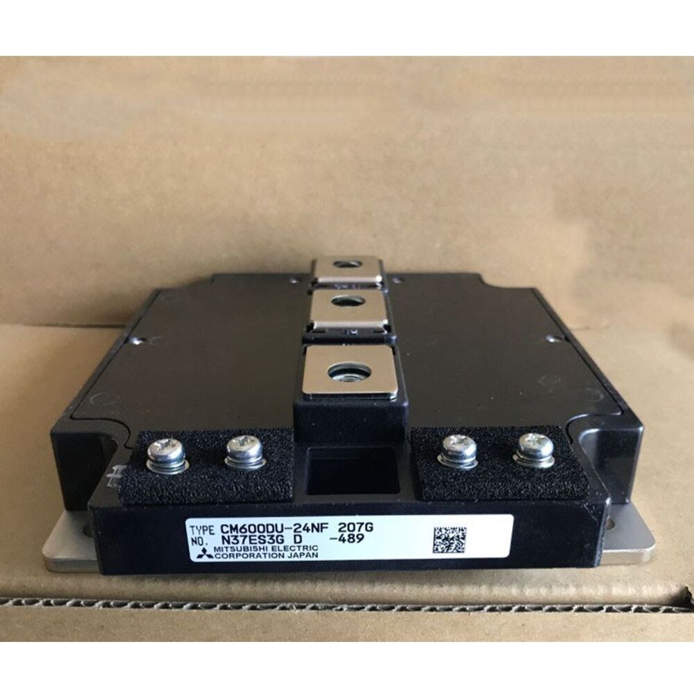 Mitsubishi CM600DU-24NF IGBT Module, black and metallic industrial component, featuring product details on a label.