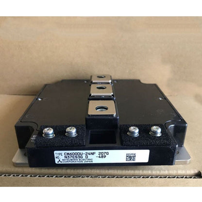Mitsubishi CM600DU-24NF IGBT Module, black and metallic industrial component, featuring product details on a label.