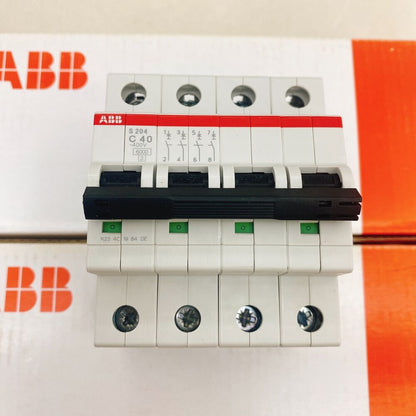 ABB S204-C40 4P 40A circuit breaker. White body, black handle, green indicators. PLC component.