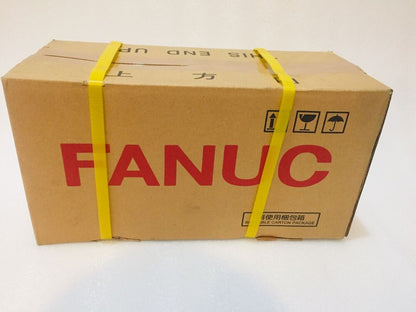 FANUC Servo Motor shipping box, cardboard packaging with yellow straps, 'THIS END UP' text, reusable carton package
