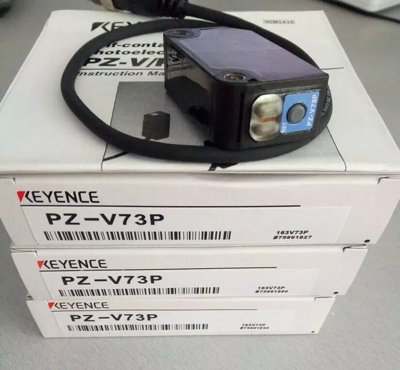 KEYENCE PZ-V73P photoelectric sensor, black housing with cable and box. Industrial automation part.