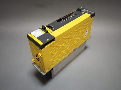 FANUC A06B-6152-H015#H580 servo drive, yellow and black, angled view, with status display.