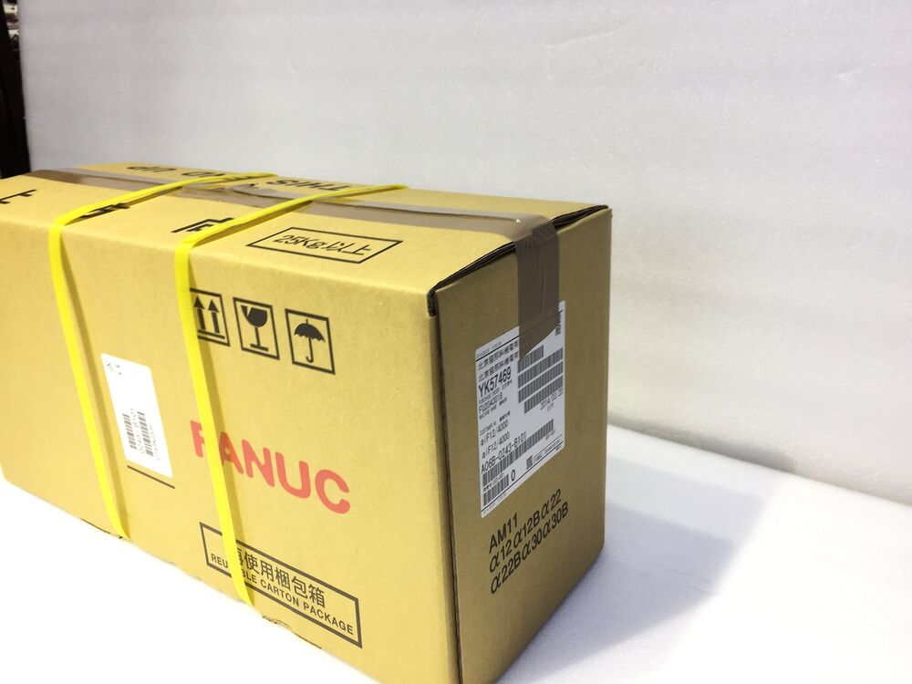 FANUC A06B-0243-B101 servo motor in shipping box, industrial automation part.
