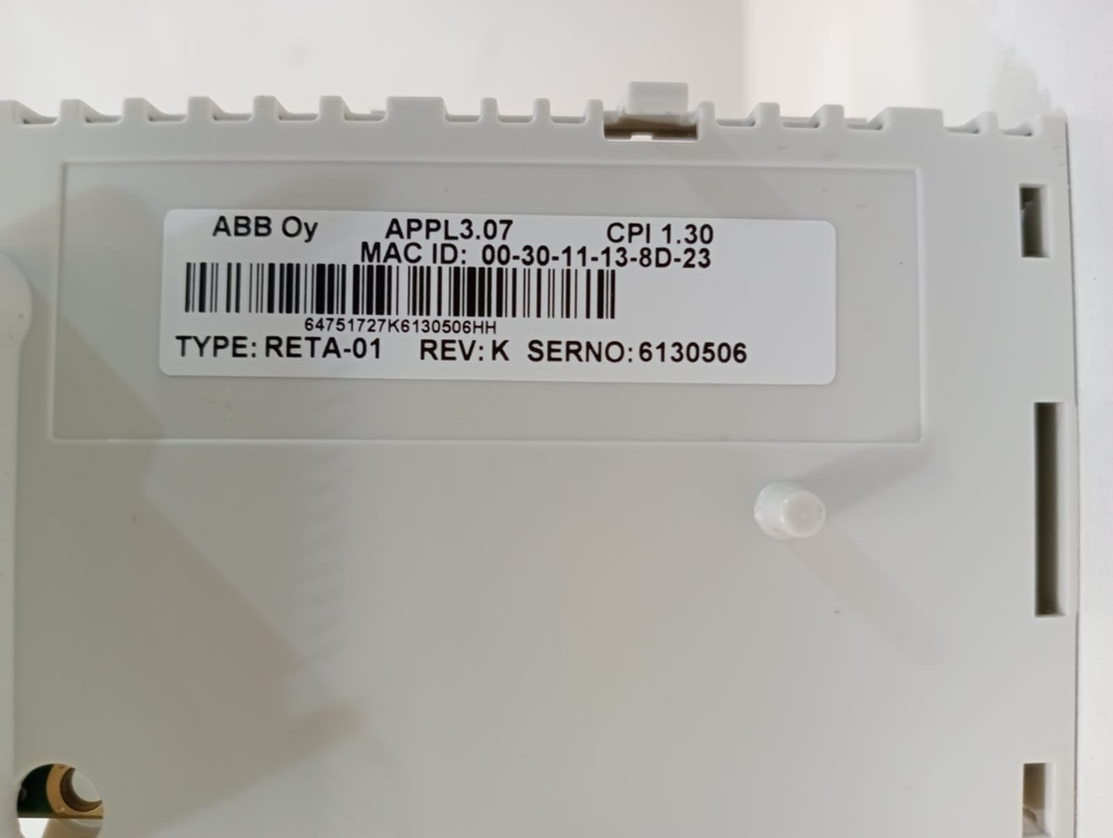 ABB RETA-01 Ethernet Adapter. White plastic enclosure with product label visible. Includes MAC ID and serial number.