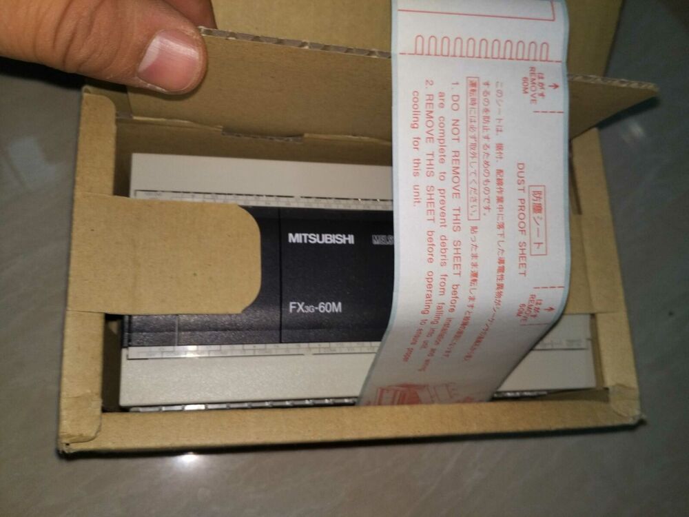 Mitsubishi FX3G-60M Programmable Controller in packaging, dust-proof sheet, industrial automation part.