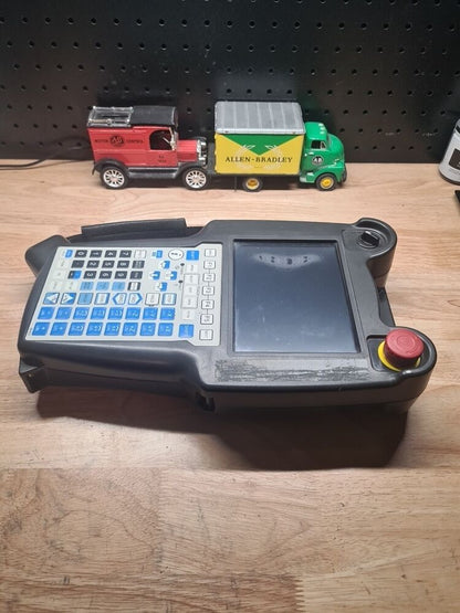 FANUC A05B-2255-C101#EMH Teach Pendant with Allen-Bradley toy truck, industrial automation equipment.