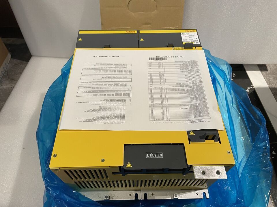 New FANUC A06B-6150-H075 Servo Amplifier, yellow and black, with product documentation, L1 L2 L3 labels visible.