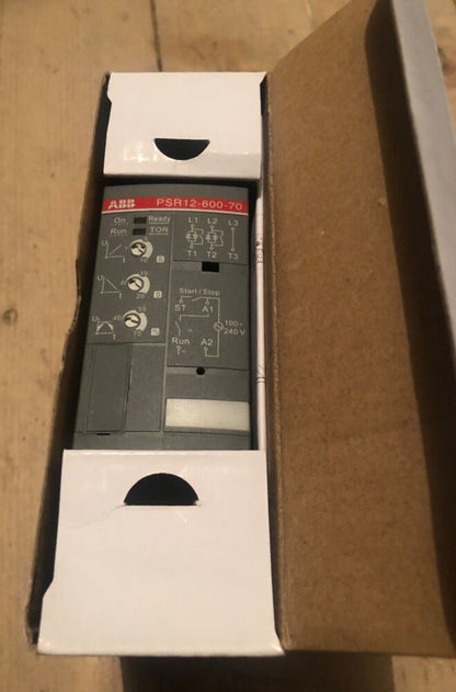 ABB PSR12-600-70 soft starter, industrial automation component inside box. Gray and white design. PLC part.