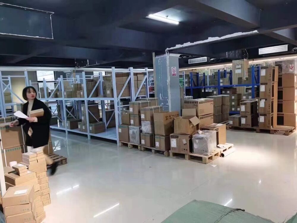 Radwell warehouse stock of automation parts, including boxes for X67BC7321-1 I/O module, with a staff member.