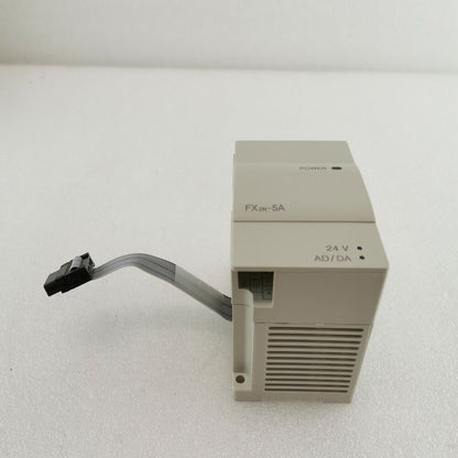 Mitsubishi FX2N-5A PLC module, beige, with 24V AD/DA and power indicator.