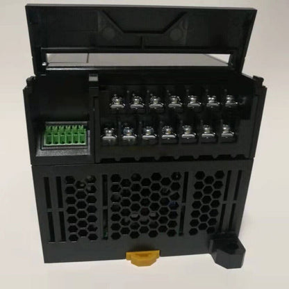Omron CP2E-E20DR-A PLC Module, black plastic housing, open lid, terminal connectors visible, industrial automation component.