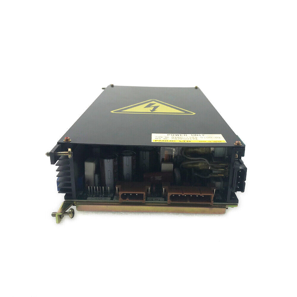 FANUC POWER UNIT A16B-1212-0100-01. Black enclosure with warning sign and internal components. Industrial automation part.
