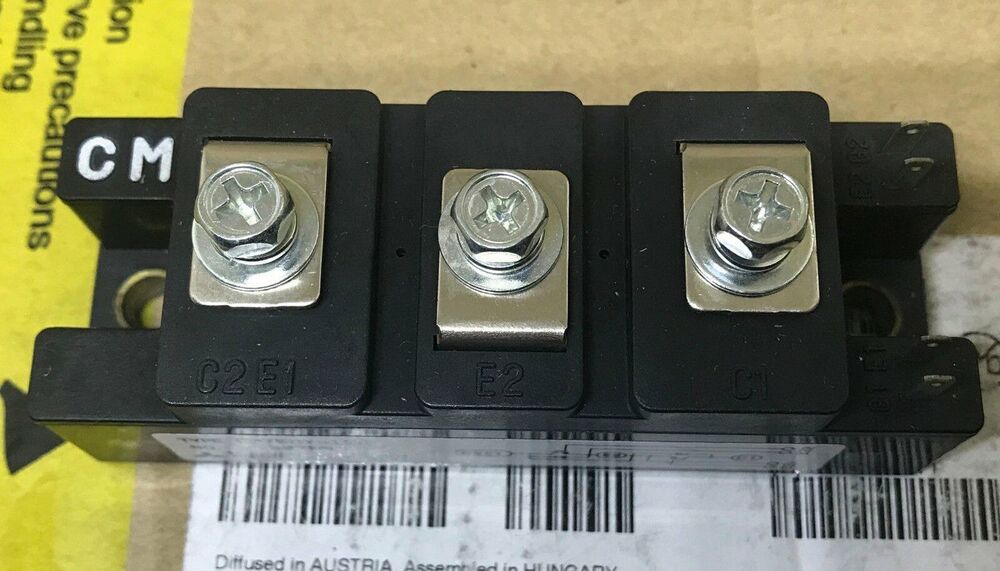 Mitsubishi CM75DY-12H power module, black plastic housing with metal terminals and screws. Industrial automation part.