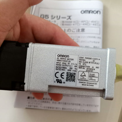 Omron R88M-K10030T-S2 AC Servo Motor detail view, silver metal housing, industrial automation part with specifications.