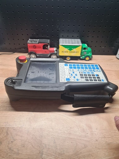 FANUC A05B-2255-C101#EMH Teach Pendant with Allen-Bradley and Motor Control toy trucks.