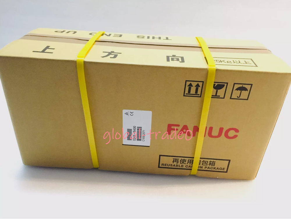 FANUC A06B-0246-B400 servo motor in box. Industrial automation part, carton packaging with direction mark.