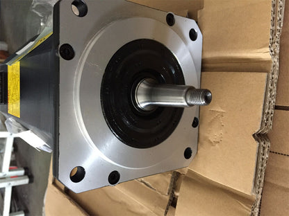 FANUC A06B-0127-B077 servo motor with silver casing and shaft, industrial automation part.