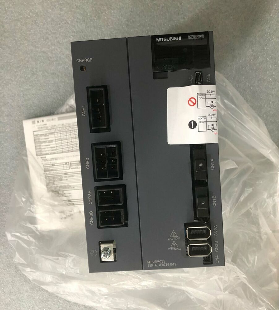 Mitsubishi MR-J3W-77B Servo Drive, grey industrial automation part with various connectors and labels. Includes MRJ3W77B.