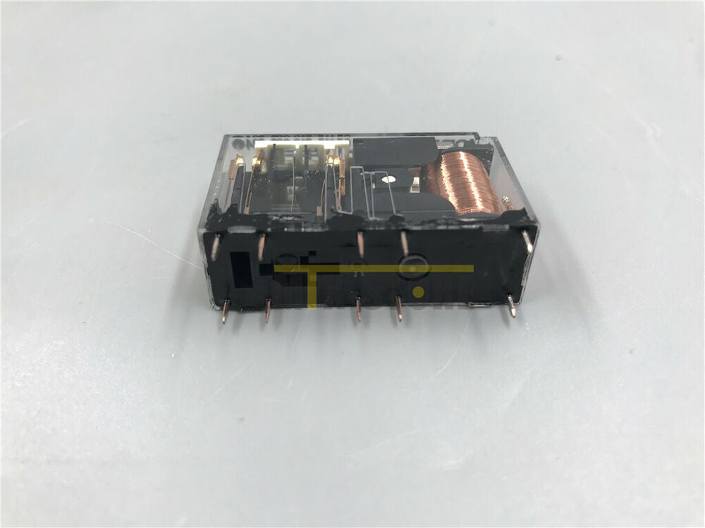 Omron G7SA-2A2B safety relay with clear plastic housing, black components, and copper coil. Industrial automation component.