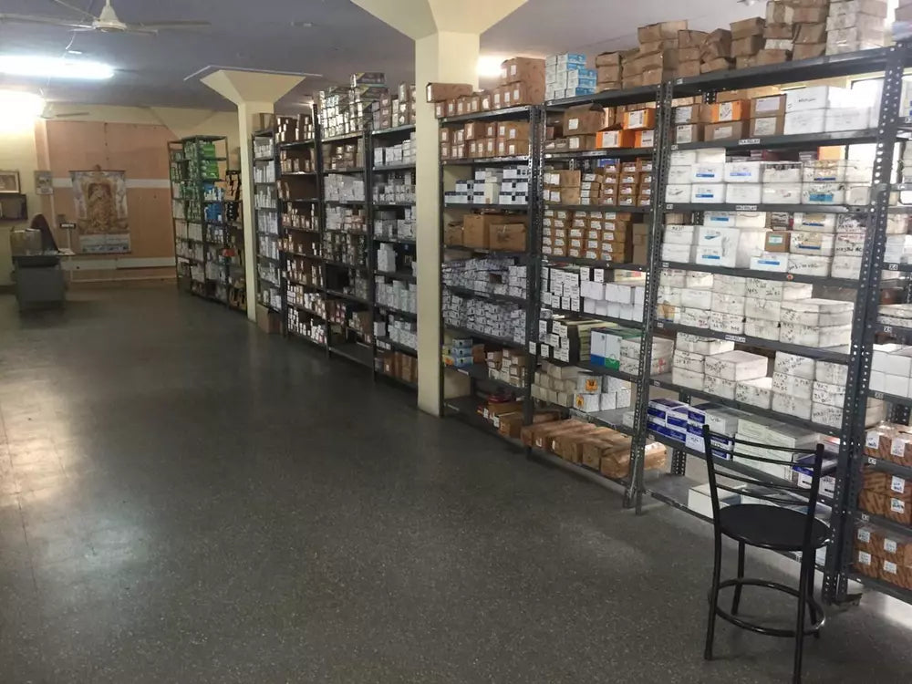Warehouse shelves stocked with Mitsubishi MR-J4-20B-RJ Servo Drive parts, in boxes ready for fast shipping.
