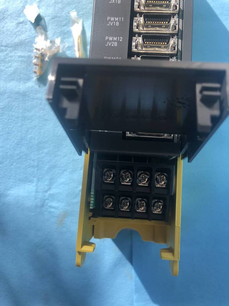 FANUC A06B-6079-H203 Servo Drive Amplifier, close-up view of the terminal block and connectors. Industrial automation part.