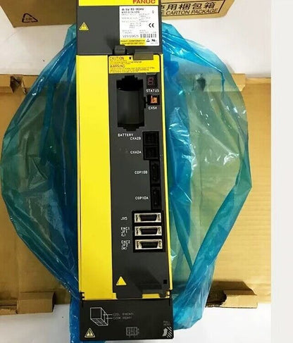 FANUC A06B-6124-H209 servo drive, new boxed industrial automation part, with warning label, detail view.