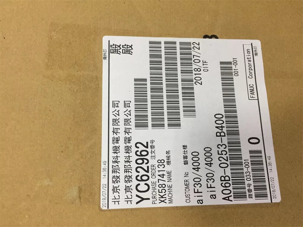 FANUC A06B-0253-B400 servo motor label with purchase order details and date, industrial automation part.