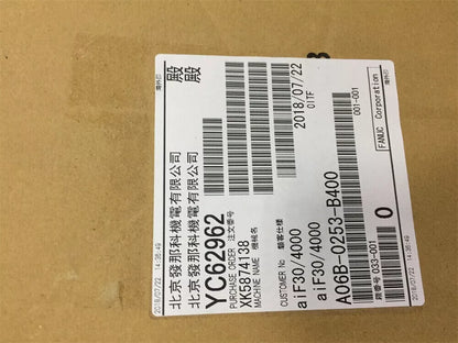 FANUC A06B-0253-B400 servo motor label with purchase order details and date, industrial automation part.