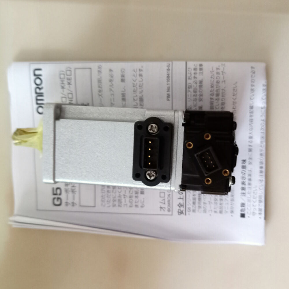Omron R88M-K10030T-S2 Servo Motor with manual. Industrial automation part for sale.