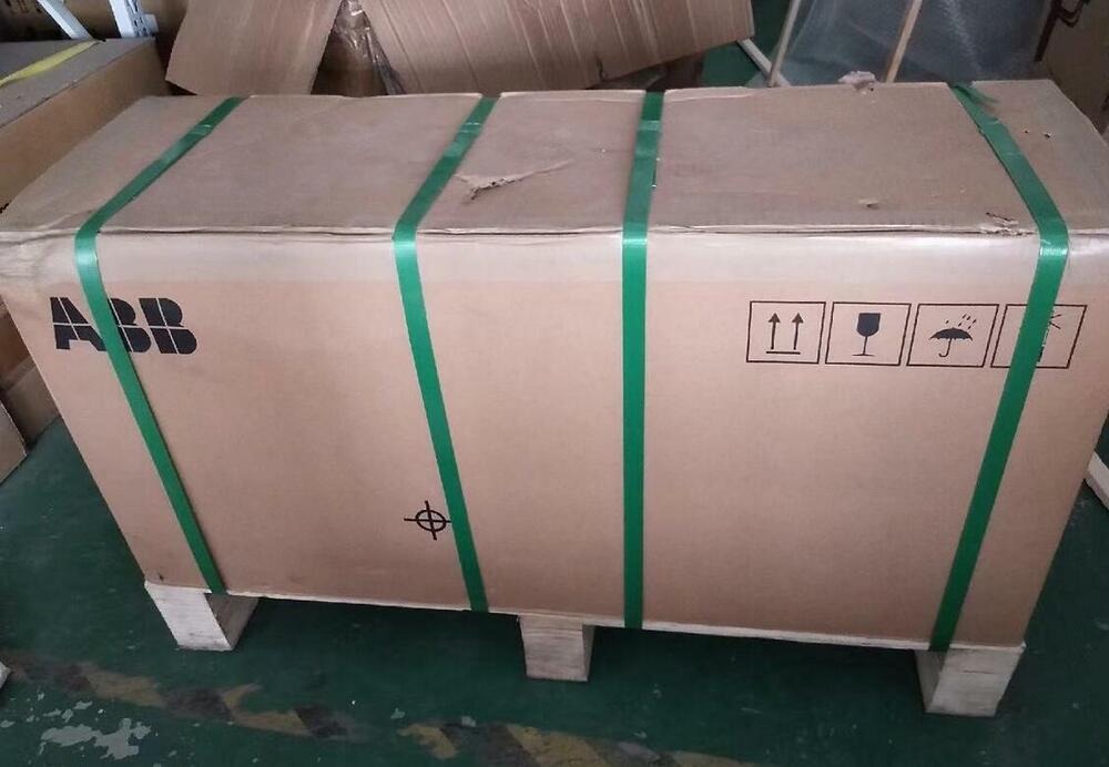 ABB ACS880-01 VFD in a cardboard box, secured with green straps, ready for shipping.