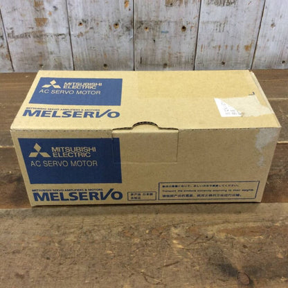 Mitsubishi MELSERVO AC Servo Motor box on wooden surface. Industrial automation part.