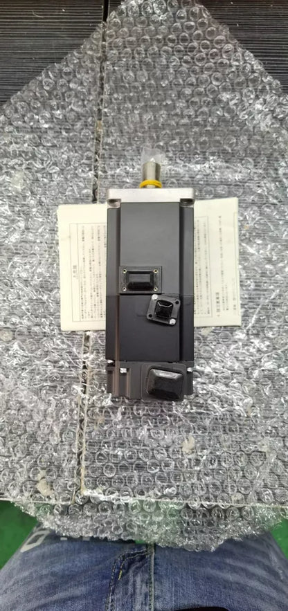 Mitsubishi HF-MP43B AC Servo Motor in protective packaging. Industrial automation equipment part.