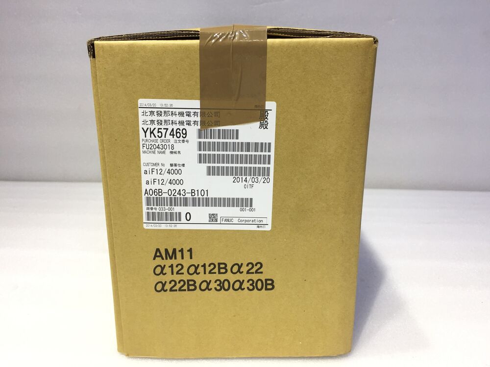 FANUC A06B-0243-B101 Servo Motor in box, industrial automation spare part, includes YK57469 label and AM11 model number.