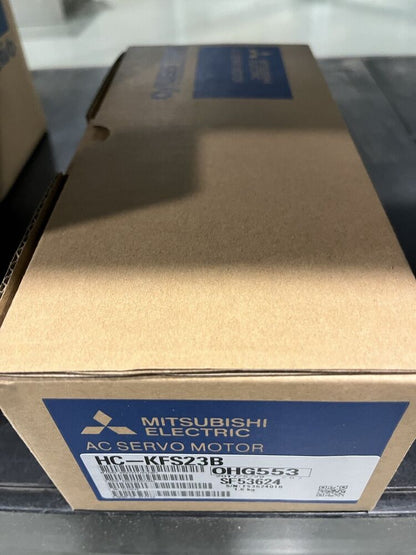 Mitsubishi HC-KFS23B AC Servo Motor in its original cardboard box, angled view. Brand logo and product details visible.