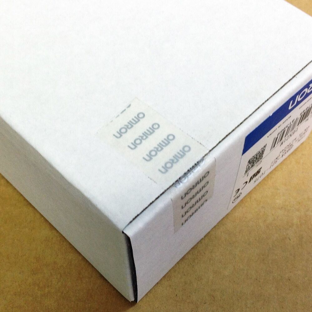 Omron G9SA-321-T075 Safety Relay Unit box corner with Omron logo stickers. Industrial automation part packaging.