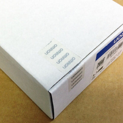 Omron G9SA-321-T075 Safety Relay Unit box corner with Omron logo stickers. Industrial automation part packaging.