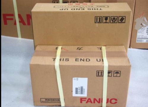 FANUC A06B-0215-B200 servo motor packaged for shipping, cardboard boxes with 'This End Up' labels.