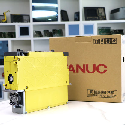FANUC A06B-6220-H015#H600 Servo Drive Amplifier. Yellow industrial automation component with box.