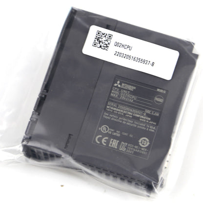 Mitsubishi Q02HCPU PLC Module in packaging, featuring product details and specifications. Industrial automation part.
