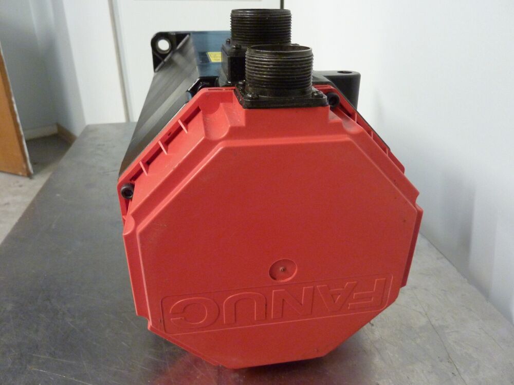 Fanuc A06B-0151-B077 AC Servo Motor, red housing, industrial automation part, close-up view, angled