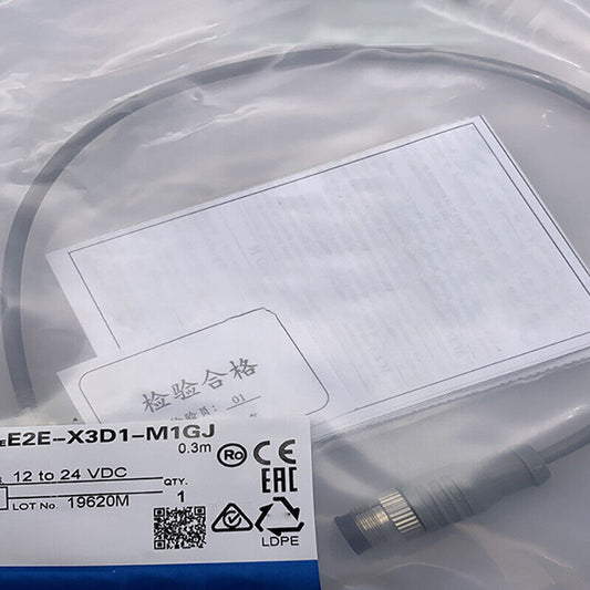 Omron E2E-X3D1-M1GJ Proximity Switch in packaging. Includes labels with specifications, CE and EAC marks, and 0.3m cable.