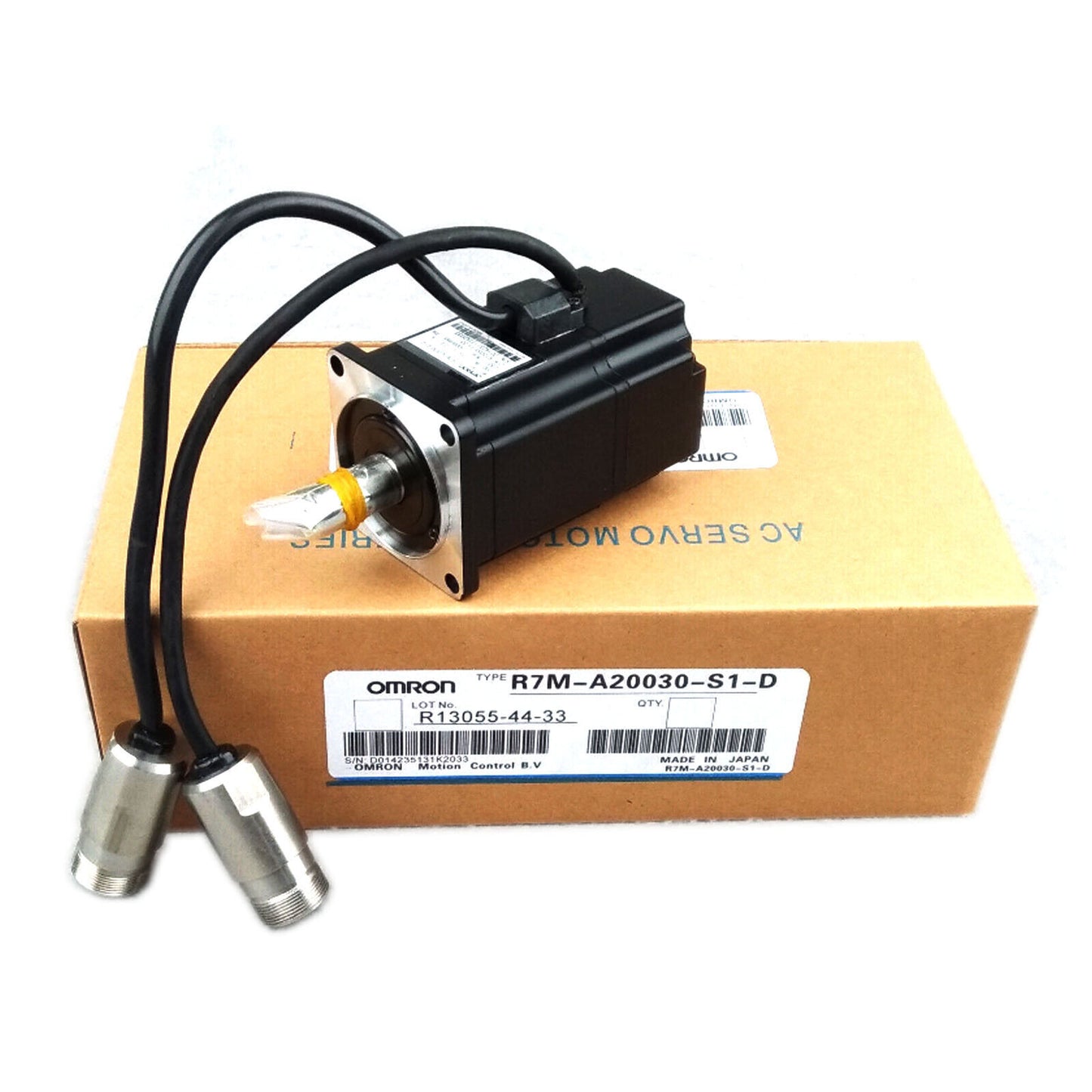 Omron R7M-A20030-S1-D servo motor on box, black motor with cables, industrial automation part.